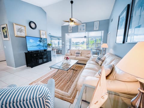 Living room, smart TV with sliding doors to pool deck and lake views
