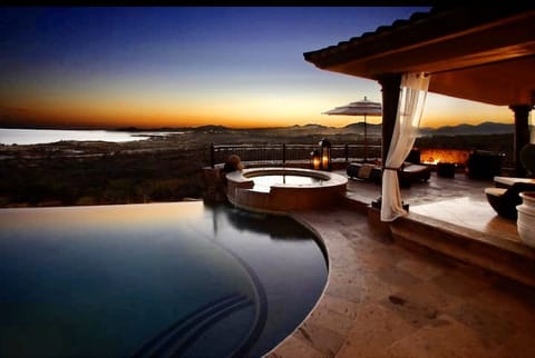 pool and hot tub with sunset view