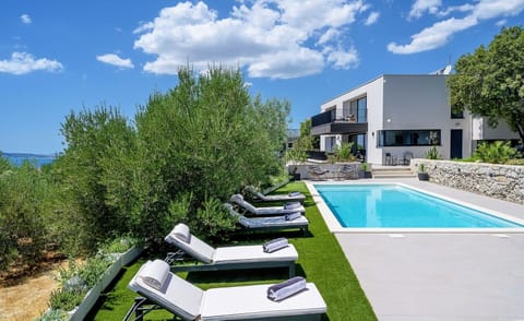 Deck chairs by the heated pool of the luxury vacation villa in Split