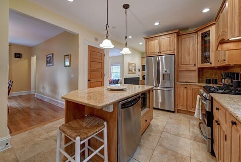 View into dining room and living room. Dishwasher and microwave, full size fridge 
