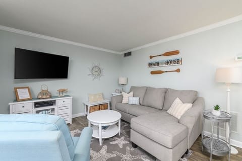 Living room with new sofa queen sleeper (Jan. 2024), recliner, big screen tv