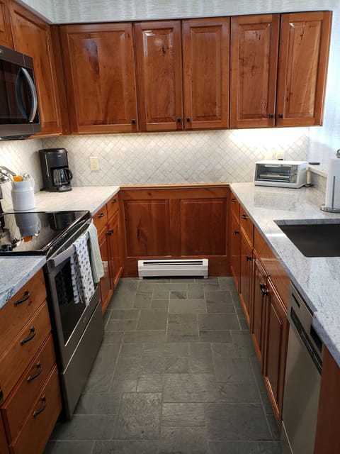 Cherry cabinets, slate floor and granite counters.