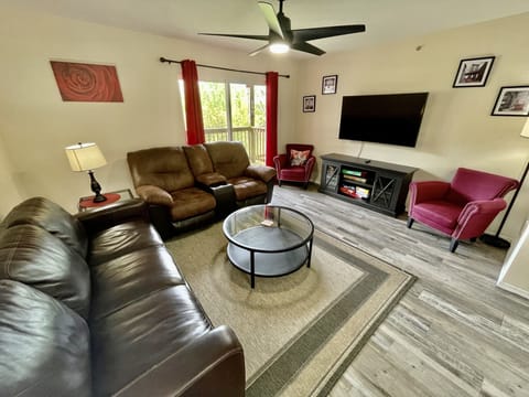 Family room with sleeper sofa and loveseat and 55" smart TV