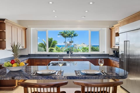 The kitchen bar with seating for two and ocean views for quick meals or entertainment.