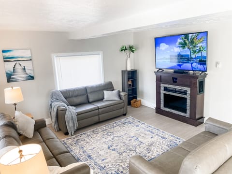 Living Room with fireplace and 65 inch TV