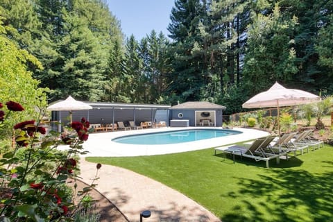 Pool with pergola and pool house