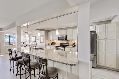 Kitchen Features a Large Breakfast Bar with Seating for 4 at 1415 South Beach Villa