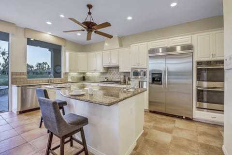 The fully-equipped kitchen features stunning stainless steel appliances.