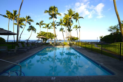 Pool area with lounge chairs and tables 