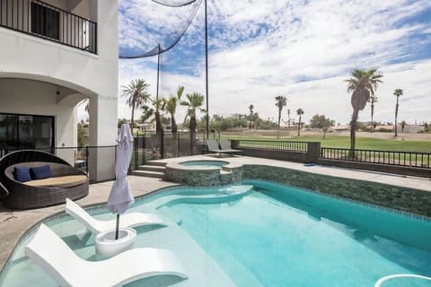 Lounge in the backyard pool overlooking palms on a golf course.
| Casa Havasu by Boutiq Luxury Vacation Rentals | Lake Havasu City, Arizona”