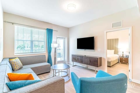 Comfortable living room with a TV and hardwood flooring.