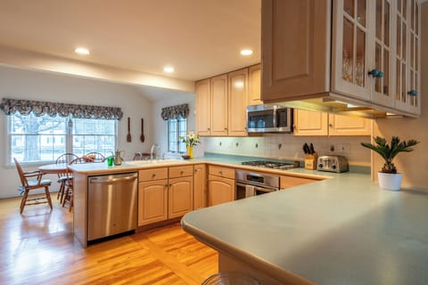 Kitchen with 4 burner gas range and oven. 