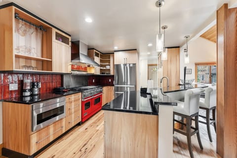 Kitchen: Viking appliances, drip coffee maker, Keurig, cooking utensils, tableware, bar seating