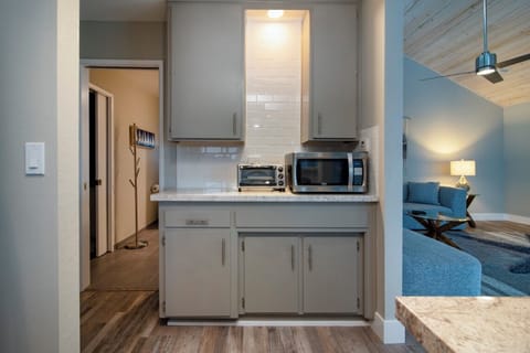 Kitchen sidebar has a toaster oven and microwave