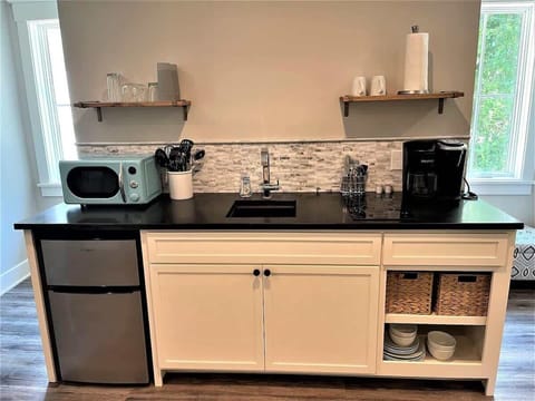 A well-equipped station with clean white cabinetry and dark countertops