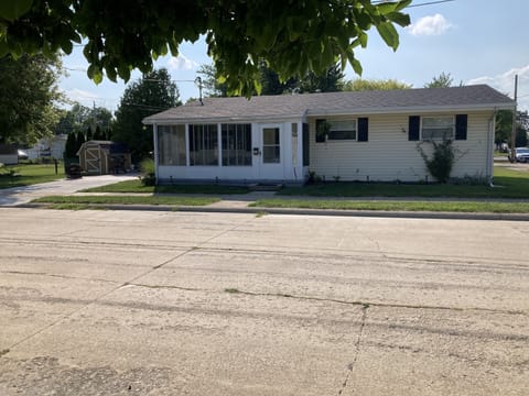 front of 312 Beech St. , showing front porch with side patio/driveway and yard
 