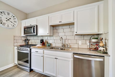 Kitchen with dishwasher, stove and farm sink