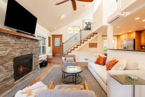 Living Room with 48" Smart TV, gas fireplace, plush furnishings, and Private BBQ patio access