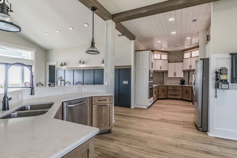 Huge kitchen with 2 refrigerators, 2 sinks and 2 dishwashers