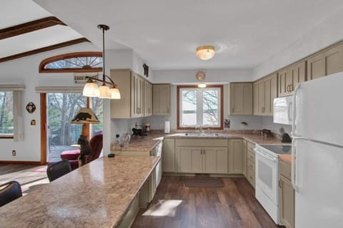 Kitchen with a dishwasher, fridge, and a view
