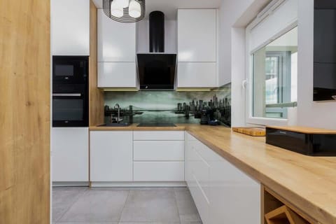 A modern kitchen with an open design, wooden accents, and a functional island separating it from the dining area.