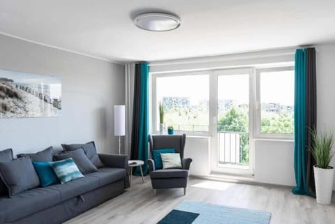 Relax in the stylish living room with a comfortable sofa and modern decor.