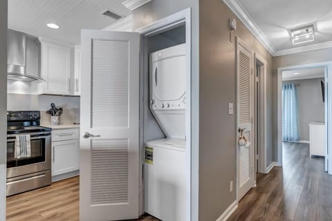 - Convenient in unit laundry with stacked washer and dryer tucked behind folding doors
- Centrally located near the kitchen for quick and easy access during your stay
- Perfect for extended stays or beach trips with fresh clothes daily