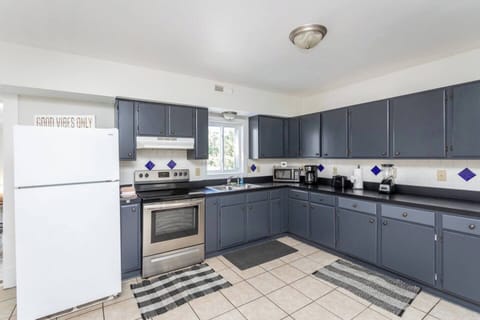 Fully stocked kitchen with oven, refrigerator, and microwave. 