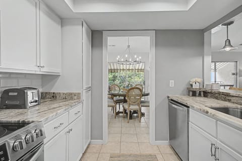 Your gourmet kitchen awaits with granite counters, stainless appliances, and elegant white cabinetry—perfect for creating memorable meals during your stay.