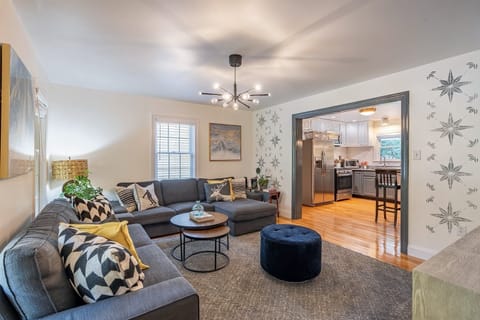 Living room #1 with 75" Smart TV open layout to kitchen.