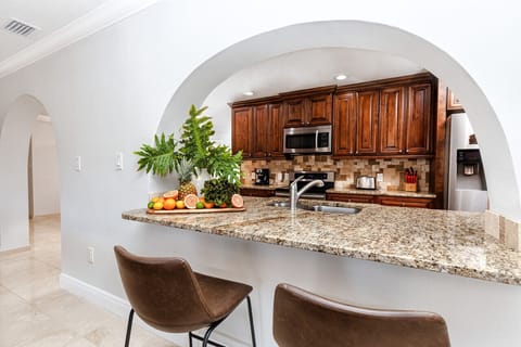 Bar between kitchen and billiard room