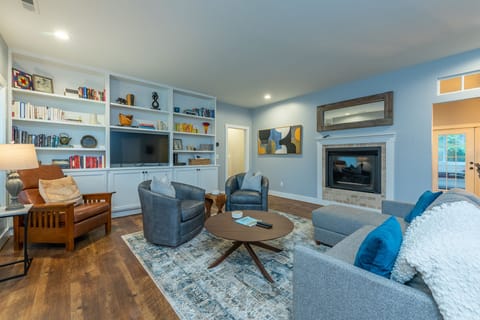 Unwind with a smart TV, gas log fireplace, and comfy seating in the open-concept living room.