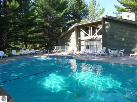 Summer access to outdoor pool at Pinebrook Condos on M-88