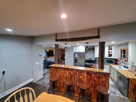 Dining area with table that seats 4 and 4 Bar stools