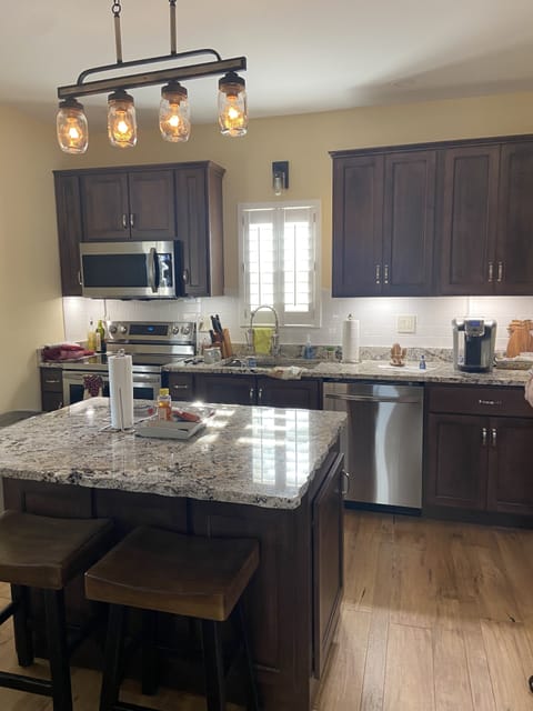 Kitchen, granite tops, custom cabinets, stainless steel appliances and hardwood