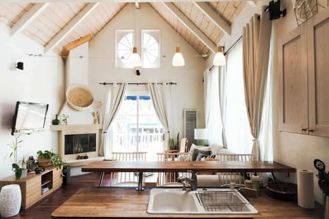 Bright & Airy Living Room with a Sofa Bed Relax in our sunlight living room features a plush sofa, stylish decor, and floor-to-ceiling windows that bring in the natural light