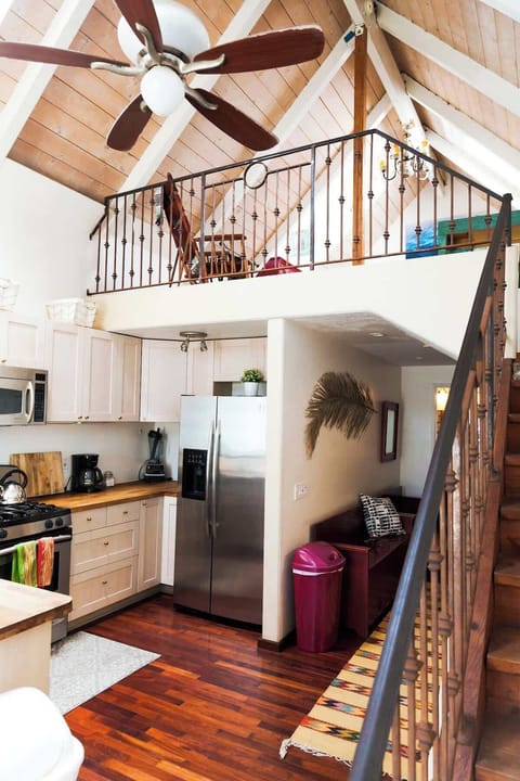 Escape to this stunning loft-style cabin with a high vaulted ceiling, a fully equipped modern kitchen, and a warm rustic ambiance.