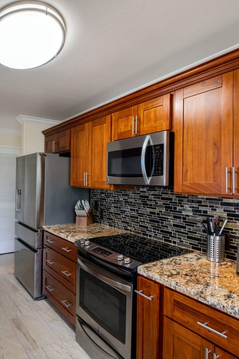 Large, well-appointed kitchen with modern appliances, ample counter space, and a direct view of the ocean as you cook.