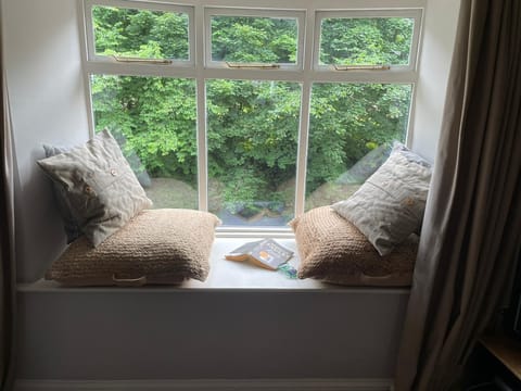 Enjoy a book or spot the local heron from the cosy riverside reading nook