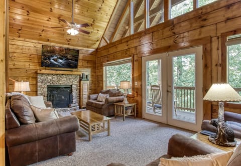 Spacious living room area with 65 inch LED TV and small board game table. 