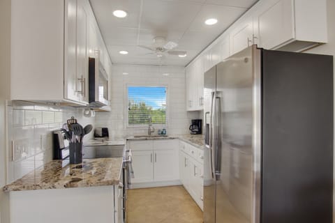 Renovated kitchen, fully stocked with cooking/eating/drinking utensils.