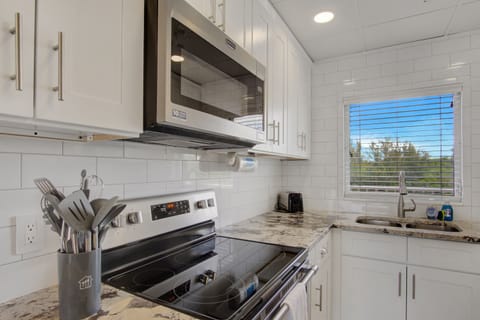Renovated kitchen, fully stocked with cooking/eating/drinking utensils.