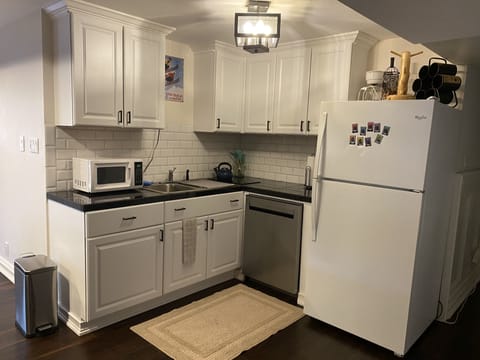 Kitchen with dishwasher, full fridge, 2 burner stove top,  coffee maker, etc. 