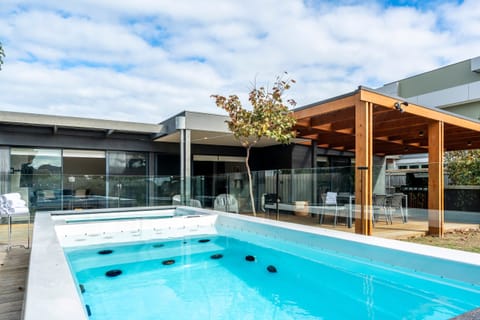 A heated swim spa in the backyard offers maximum relaxation and year-round enjoyment.