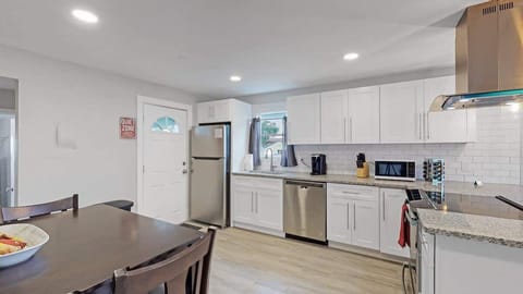 Fully Equipped Kitchen – Featuring modern appliances, cookware, tableware, cutlery, and a stocked Keurig, perfect for preparing meals and enjoying coffee with ease.