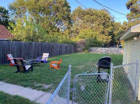 Fenced in yard with fire pit.