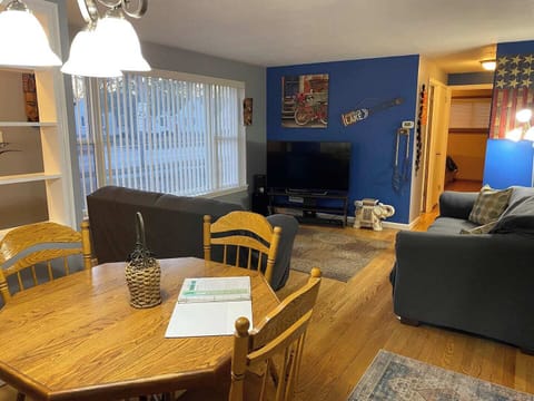 Entry view: Family room with full size 3 seat couch and love seat sofa. Large window great for natural lighting 