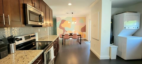 View of dining room from kitchen. Laundry washer/dryer conveniently located.
