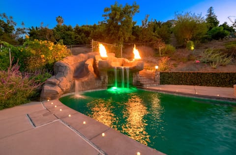 Ride the 20" water slide or jump off the waterfall while the fire goblets roar!