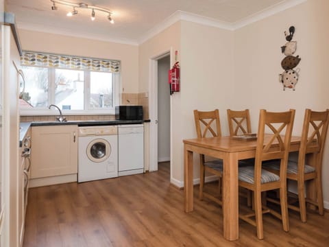 Kitchen/diner | Dolphin Cottage - Celtic Haven Resort, Lydstep, near Tenby